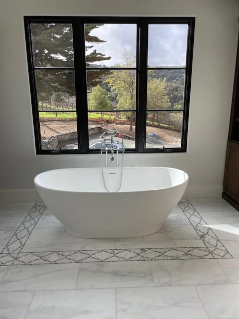 Luxury residential freestanding soaking tub and bathroom plumbing
